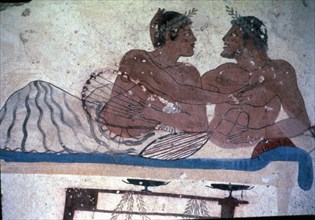 Fresco in the tomb of Tuffatore representing two men at a banquet.