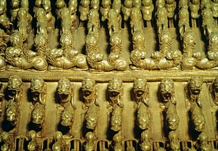 Detail of a gold pectoral with zoomorphic figures round shaped.