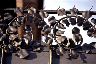 Detail of wrought iron with floral motifs of the old Modernist textile factory Casaramona's gate,?