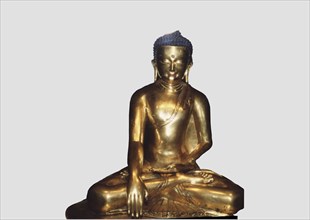 Gilded copper figure representing the Shakyamuni Buddha. Tibet, 13th century.