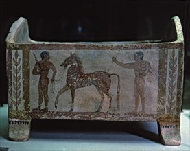 Etruscan funerary urn decorated with two men and a horse, preserved in the National Etruscan Muse?