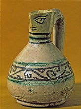 Vase with scoop anthropomorphic shaped decorated in green and black. Manresa pottery discovered i?
