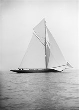 The 221 ton gaff-rigged cutter 'Britannia' sailing under spinnaker 1913. Creator: Kirk & Sons of Cowes.