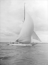 'Istria' sailing downwind under spinnaker, 1912.  Creator: Kirk & Sons of Cowes.