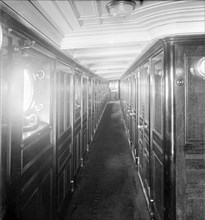 Long wood panelled corridor on steam yacht 'Venetia', 1920. Creator: Kirk & Sons of Cowes.