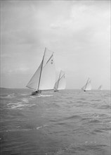 Group of 8 Metres sailing yachts racing downwind, 1913. Creator: Kirk & Sons of Cowes.