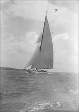The 23-metre cutter 'Astra' sailing close-hauled, 1933. Creator: Kirk & Sons of Cowes.