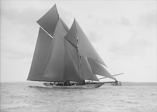 The 250 ton schooner 'Germania' sails on a reach, 1913. Creator: Kirk & Sons of Cowes.