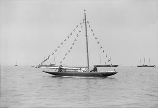 The 6 Metre 'Cremona' moored with flags, 1913. Creator: Kirk & Sons of Cowes.