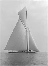 The towering 10,450 sq ft sail area of 'Shamrock IV', 1914. Creator: Kirk & Sons of Cowes.