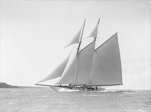 The 250 ton schooner 'Germania' reaching in stiff wind, 1912. Creator: Kirk & Sons of Cowes.