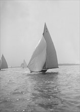 The 7 Metre yacht 'Pinaster' (K8) sailing with spinnaker, 1914. Creator: Kirk & Sons of Cowes.