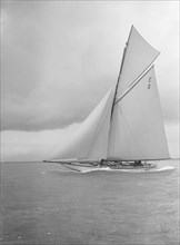 The 12 Metre 'Ierne' sailing close-hauled, 1912. Creator: Kirk & Sons of Cowes.