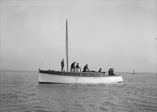 Sailors on board cabin cruiser, 1914. Creator: Kirk & Sons of Cowes.