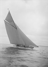 The 12 Metre yacht 'Alachie' makes swift progress upwind, 1911. Creator: Kirk & Sons of Cowes.