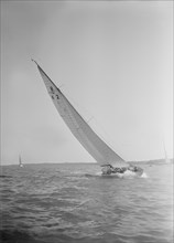 The 8 Metre class sailing yacht 'Carron' (K2), heeling upwind in a good breeze, 1934. Creator: Kirk & Sons of Cowes.