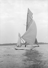 The 8-metre 'Ierne' sailing with spinnaker, 1913. Creator: Kirk & Sons of Cowes.