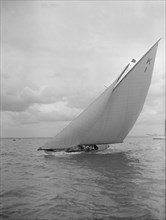 The 7 Metre 'Marsinah' (K1) sailing close-hauled, 1912. Creator: Kirk & Sons of Cowes.