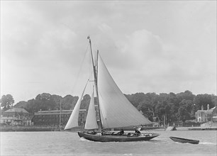 The 9 ton auxilary cutter 'Grayling' with  tender, 1921. Creator: Kirk & Sons of Cowes.