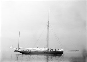 The gaff yawl 'Coral' at anchor, 1922. Creator: Kirk & Sons of Cowes.