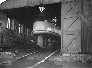 Egyptian motor launch in shed, 1911. Creator: Kirk & Sons of Cowes.
