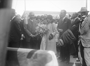 Woman with bouquet, c1935. Creator: Kirk & Sons of Cowes.