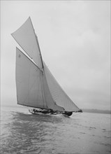 The 45 ton cutter 'Camellia' sailing close-hauled, 1911. Creator: Kirk & Sons of Cowes.