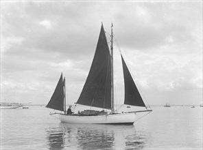 The 4 ton yawl 'Mandy' under sail, 1922. Creator: Kirk & Sons of Cowes.
