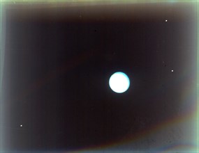Uranus with satellites Miranda, Ariel and Umbriel, from Voyager 2, 24 January 1986. Creator: NASA.