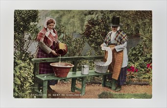 Cleanliness is next to Godliness.  Women in Welsh costume washing in tubs on bench, c1900s