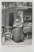 Jane Jones in Welsh Costume at her bookstall in Betws-y-coed, c1910.