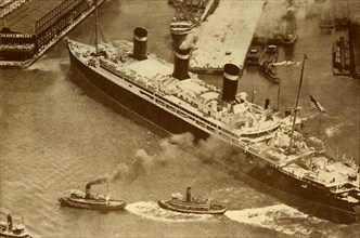 An Aerial Photograph of the "Leviathan" Being Towed By Small Tugs Into Her Dock At New York', c1930