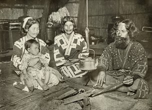 Ainu Man and Women at Home', 1910.