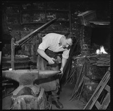 Blacksmith working at an anvil, 1967