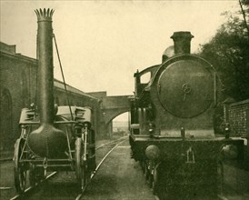 A full size model of Stephenson's Rocket alongside an engine of the "George the Fifth" class, Londo