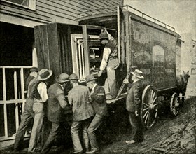 Loading The Camera On A Van For Removal', 1901.
