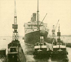 The "Majestic" Entering Dry Dock Hauled by Tugs', c1930.