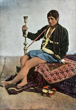 Persane Fumant Le Kalgan', (Persian woman smoking in Kalgan), 1900.