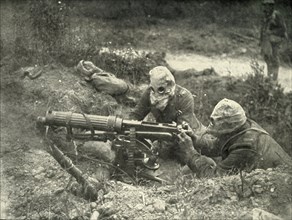 Machine Gunners in Action Wearing their Gas Helmets', (1919).
