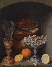 Still life with a wineglass, oranges, a plate with mushrooms and a silver cup, Early 17th cen..