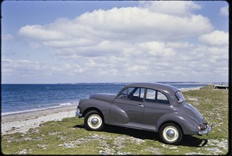Morris Minor parked on the seafront, Traeth Llanddwyn, Anglesey, North Wales, 1962