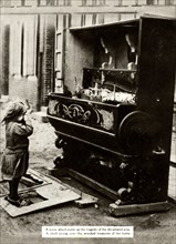 Child with damaged piano after an air raid made her homeless, First World War