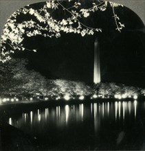 'When It Is Cherry Blossom Time in Washington - A Lovely Night View of Washington Monument', c1930s. Creator: Unknown.