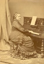 Portrait of Clara Wieck-Schumann (1819-1896) at the piano, ca 1878. Creator: Hanfstaengl, Franz (1804-1877).