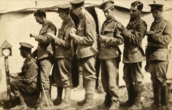 British soldiers synchronising their watches on the front line, First World War, 1914-1918, (1933). Creator: Unknown.