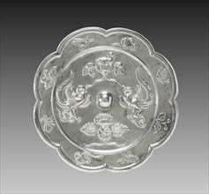 Lobed Mirror with Paired Phoenixes, a Nestling Bird, and a Lotus Blossom, 700s. Creator: Unknown.