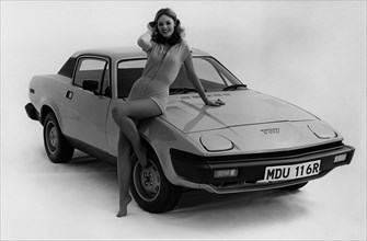 1976 Triumph TR7 with female model. Creator: Unknown.