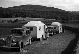 1937 Hillman 14 towing caravan. Creator: Unknown.