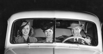 1939 Oldsmobile driver and female passengers. Creator: Unknown.