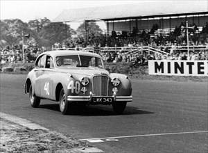 1953 Jaguar MkVII, Stirling Moss at Silverstone. Creator: Unknown.